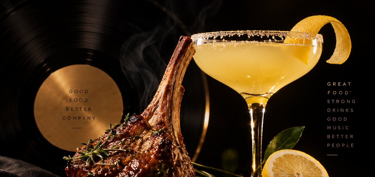 A lamb chop and a lemon drop cocktail styled on a vinyl record